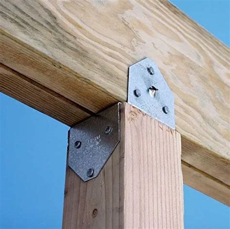 metal bracket imbedded in concrete for double 2x8|post base connectors.